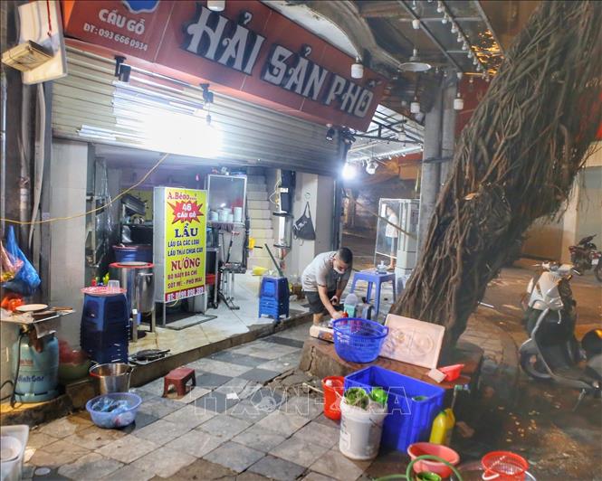 Nhà hàng hải sản trên phố Cầu Gỗ, quận Hoàn Kiếm chủ động dọn dẹp, đóng cửa trước 21 giờ (Ảnh chụp lúc 20h36). Ảnh: Tuấn Đức - TTXVN