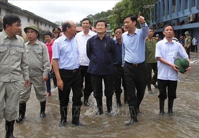 Chủ tịch nước Trương Tấn Sang kiểm tra tình hình khắc phục hậu quả do đợt mưa lũ gây ra tại Công ty than Mông Dương và tỉnh Quảng Ninh, tháng 8/2015. Ảnh: Nguyễn Khang – TTXVN