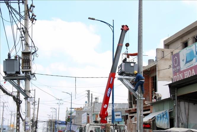 Trong ảnh: Ngành điện lực đang triển khai thi công trụ mới để thay thế hệ thống điện hiện có. Ảnh: Tiến Lực – TTXVN