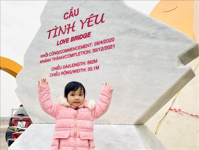 Trong ảnh: Tấm biển khắc tên cầu Tình Yêu là điểm nhấn ghi dấu trong mọi bức ảnh của người dân khi check in tại đây. Ảnh: Thanh Vân-TTXVN