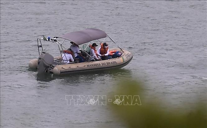 Trong ảnh: Lực lượng cứu hộ tìm kiếm nạn nhân tại hiện trường vụ sập vách đá ở hồ Furnas, thành phố Capitolio, bang Minas Gerais, Brazil ngày 9/1/2022. Ảnh: AFP/TTXVN