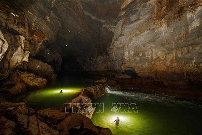 Photo: The underground river system has different colours, where the water is slow flowing, algae thrives and gives the river green colour. VNA Photo