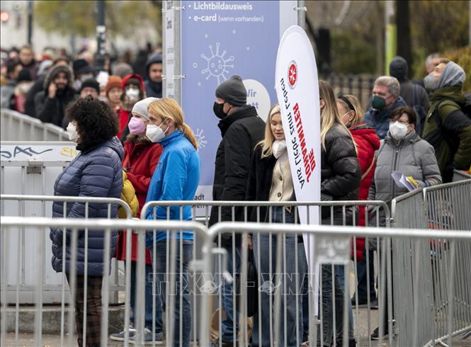 Trong ảnh: Người dân xếp hàng chờ tiêm vaccine phòng COVID-19 tại Vienna, Áo, ngày 15/11/2021. Ảnh: AFP/TTXVN