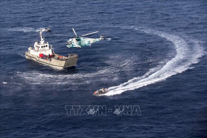 Trong ảnh: Binh sĩ Iran, Nga và Trung Quốc tham gia  cuộc tập trận trên không và trên biển ở Ấn Độ Dương nhằm chống cướp biển ngày 21/1/2022. Ảnh: AFP/TTXVN