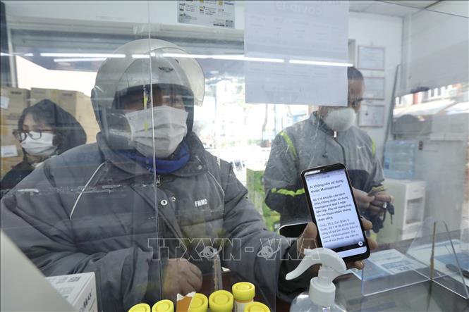 Trong ngày mở bán đầu tiên, nhiều khách hàng đến hỏi mua thuốc Molnupiravir điều trị COVID-19 nhưng đành quay về vì không có chỉ định của bác sĩ và giấy xác nhận F0. Ảnh: Minh Quyết - TTXVN