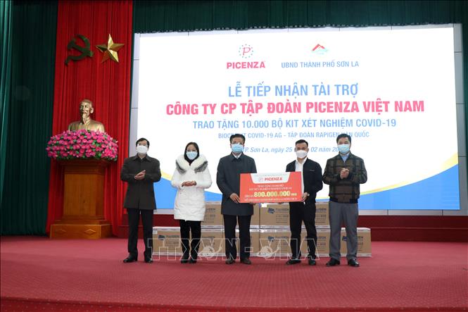 Trong ảnh: Đại diện thành phố Sơn La tiếp nhận kit test nhanh COVID-19 do doanh nghiệp trao tặng. Ảnh: Hữu Quyết - TTXVN