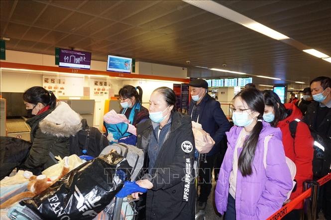 Photo: Vietnamese expats at Warsaw's Chopin airport get on board on a repatriation flight on March 9. VNA Photo: Hồng Kỳ