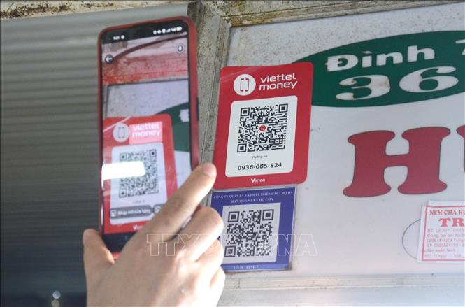Photo: Owners of over 1,000 stalls at Da Nang’s three major wet markets - Con, Han and Dong Da - have been provided with a QR code enabling users to make online payments through access with 37 banks and Viettel Money.
VNA Photo: Quốc Dũng