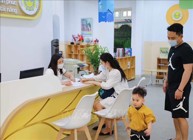 Nắm được thông tin trẻ mầm non sẽ tới trường từ ngày 13/4 tới đây, nhiều gia đình đã tới làm các thủ tục để con được đi học. Ảnh: Thanh Tùng - TTXVN