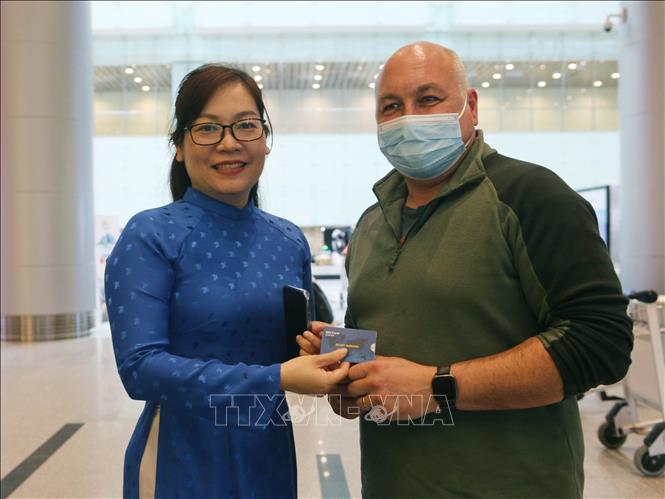 A foreign visitor  receives a free SIM card at Da Nang International Airport. VNA Photo: Trần Lê Lâm