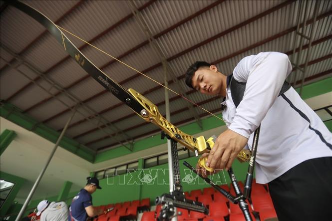 Photo: Archer has to prepare their bow carefully before practicing. VNA Photo: Minh Quyết