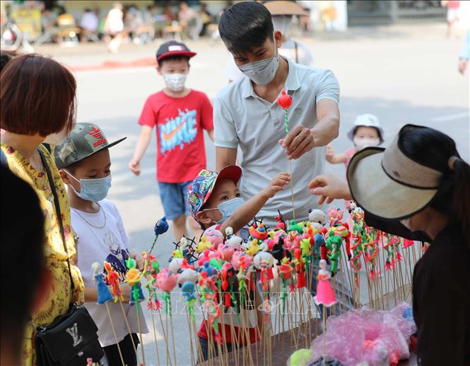 Trẻ em hào hứng với món đồ chơi tò he. Ảnh: Thanh Tùng - TTXVN