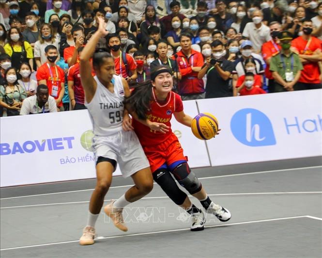 Kayleigh Truong's (No. 11, Vietnamese woman) dribbles past the block by Rujiwan Bunsinprom (No. 59, Thai woman).
