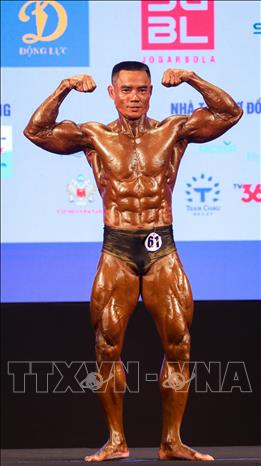 Nguyen Minh Tien ranks second to bring home a silver in the men’s classic singles. VNA Photo: Khánh Hoà