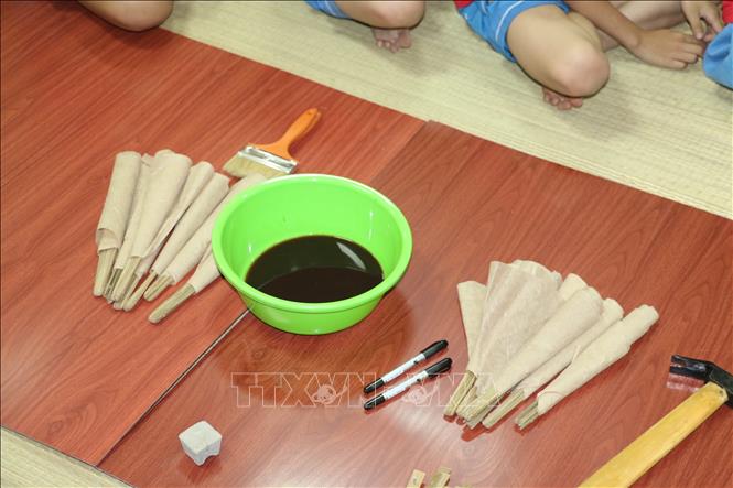 Trong ảnh: Nguyên liệu để làm quạt giấy là giấy dó, nan tre và mực. Ảnh: Bích Huệ - TTXVN