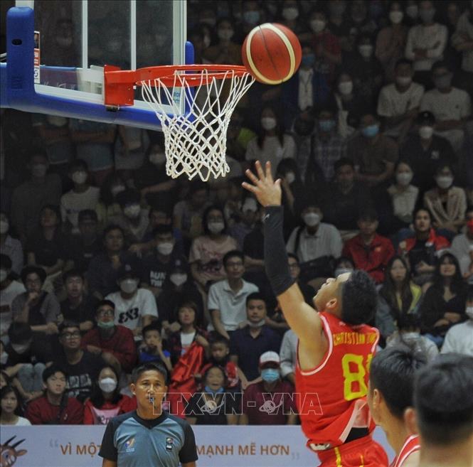 Pha ghi điểm của Christian Juzang (81, nam Việt Nam) trong trận thắng nam Singapore với tỉ số 86-83. Ảnh: Lê Thuỳ Dương - TTXVN phát