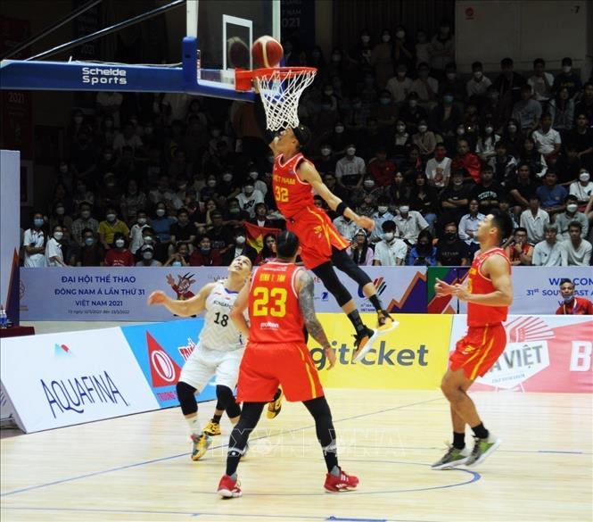 Vietnam scores into Singapore’s basket in a qualifying match of the SEA Games 31 men’s 5x5 basket ball. VNA Photo