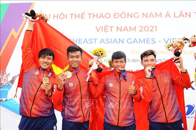 4 VĐV Hồng Quân, Quốc Toản, Hiền Nam, Trần Thanh của đội tuyển Việt Nam tận hưởng vinh quang với tấm HCV ở nội dung thuyền 4 nam Canoeing 1000m (MC4 1000). Ảnh: Minh Đức - TTXVN