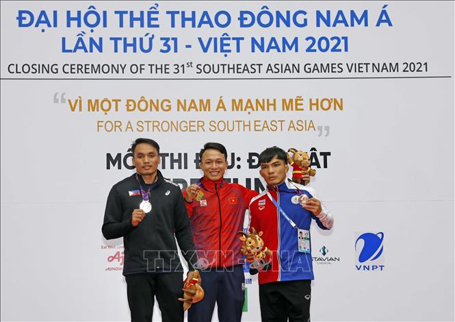 Wrestler Nguyen Xuan Dinh (middle, gold) and 2 athletes from the Philippines and Thailand receive silver and bronze medals in the 65 kg weight class. VNA Photo: Trần Việt 