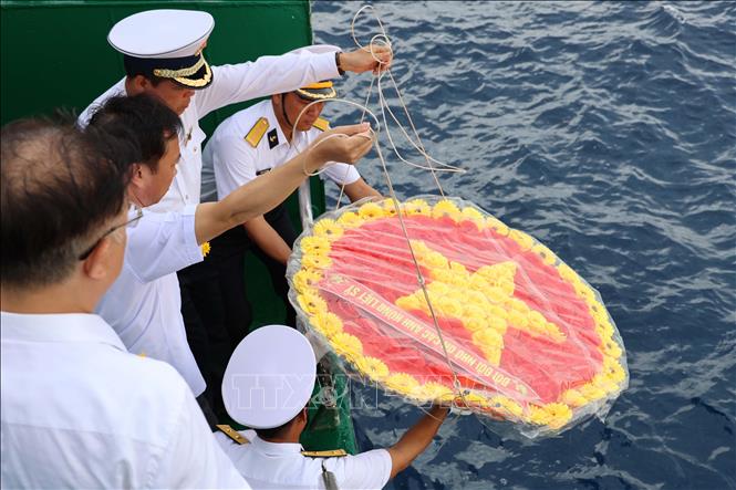 Các đại biểu kiều bào tham dự Lễ tưởng niệm cán bộ, chiến sỹ hy sinh tại quần đảo Trường Sa vì sự nghiệp bảo vệ chủ quyền biển, đảo Tổ quốc trong không khí nghiêm trang và xúc động tại boong tàu Trường Sa 571. Ảnh: Diệp Trương – TTXVN
