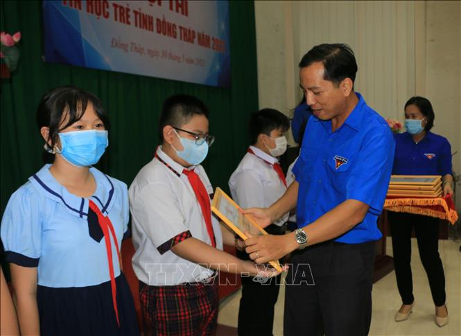 Phó Bí thư Tỉnh đoàn Đồng Tháp Nguyễn Hoàng Minh Trí trao Giấy khen cho các thí sinh (cấp Tiểu học) đạt giải cao tại Hội thi Tin học trẻ năm 2022. Ảnh: Nhựt An - TTXVN