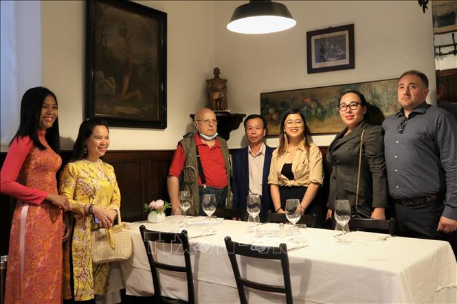 Tham tán Đại sứ quán Việt Nam tại Italy Nguyễn Thái Học và Chủ tịch Hội hữu nghị Italy – Italy vùng Lombardy Roberto Cocevari cùng với các đại diện kiều bào tại Italy chụp ảnh lưu niệm bên cạnh tượng Bác Hồ. Ảnh: Trường Dụy - P/v TTXVN tại Italy
