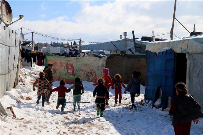 Trong ảnh: Trẻ em tị nạn Syria chơi đùa tại trại tị nạn al-Hilal ở làng al-Taybeh, thung lũng Bekaa, Liban, ngày 20/1/2022. Ảnh: AFP/ TTXVN