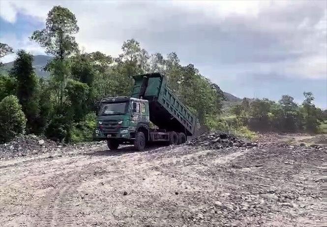 Trong ảnh: Phương tiện của Công ty Than Mạo Khê vận chuyển đất đá thải mỏ đổ đất của hộ gia đình tại phường Yên Thọ, thị xã Đông Triều (Quảng Ninh). Ảnh: TTXVN phát