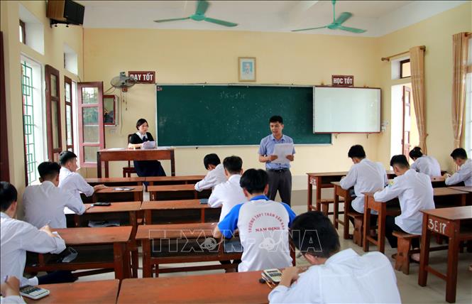 Trong ảnh: Cán bộ coi thi hướng dẫn thí sinh tại điểm thi Trường THPT Trần Văn Bảo, huyện Nam Trực, tỉnh Nam Định điền thông tin cá nhân trước khi phát đề thi môn Toán. Ảnh: Nguyễn Lành - TTXVN