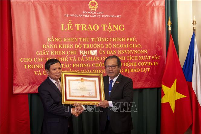 Đại sứ Việt Nam tại CH Séc Thái Xuân Dũng trao Bằng khen của Thủ tướng Chính phủ cho ông Hoàng Đình Thắng, Chủ tịch Liên hiệp Hội người Việt Nam tại châu Âu.  Ảnh: Ngọc Biên - PV TTXVN tại Séc