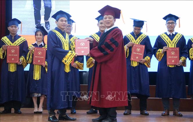 Trong ảnh: Bí thư Đảng ủy, Chủ tịch Hội đồng trường Đại học Y Dược Thái Bình, Phó Giáo sư, Tiến sỹ Nguyễn Quốc Tiến (phải) trao bằng tốt nghiệp cho lưu học sinh Vương quốc Campuchia. Ảnh: Thu Hoài – TTXVN