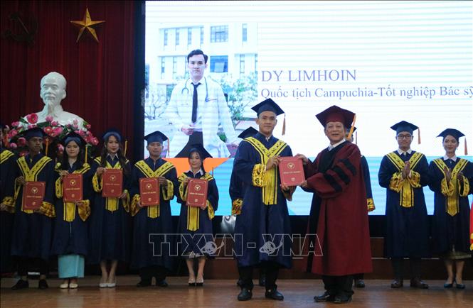 Trong ảnh: Bí thư Đảng ủy, Chủ tịch Hội đồng trường Đại học Y Dược Thái Bình, Phó Giáo sư, Tiến sỹ Nguyễn Quốc Tiến (phải) trao bằng tốt nghiệp cho lưu học sinh Vương quốc Campuchia. Ảnh: Thu Hoài – TTXVN