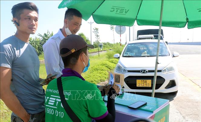 Trong ảnh: Trạm BOT cầu Bạch Đằng trên cao tốc Hạ Long - Hải Phòng bố trí tổ hỗ trợ dán thẻ định danh cho các phương tiện. Ảnh: Văn Đức - TTXVN
