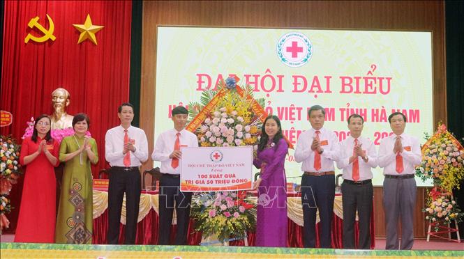 Trong ảnh: Bà Huỳnh Thị Xuân Lam, Phó Chủ tịch Trung ương Hội Chữ thập đỏ Việt Nam tặng hoa chúc mừng Đại hội và 100 suất quà cho người có hoàn cảnh khó khăn tỉnh Hà Nam. Ảnh: Nguyễn Chinh - TTXVN