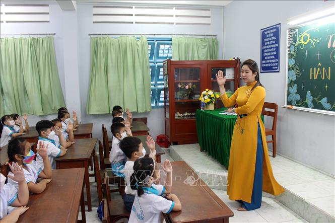 Trong ảnh: Cô giáo hướng dẫn cho học sinh về các quy định tại lớp học. Ảnh: Hữu Chí - TTXVN
