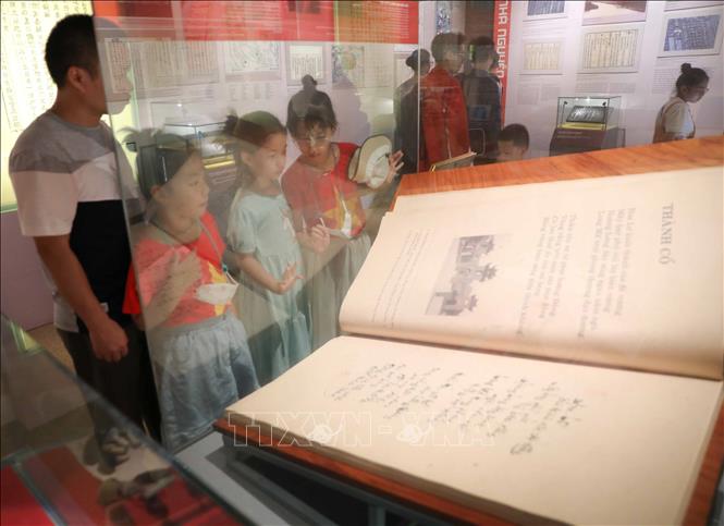 Các em thiếu nhi cùng bố mẹ tham quan, tìm hiểu về Hoàng thành Thăng Long. Ảnh: Thanh Tùng - TTXVN