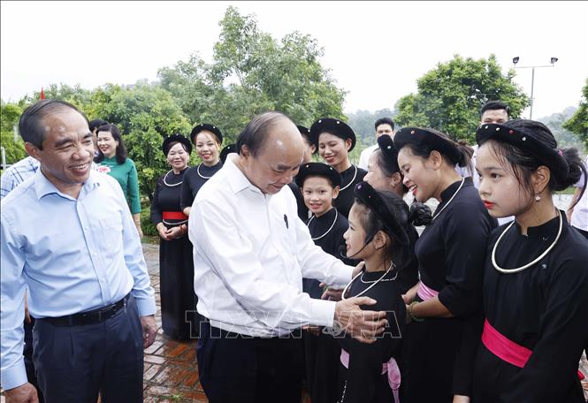Chủ tịch nước Nguyễn Xuân Phúc nói chuyện với các thành viên Câu lạc bộ hát Then thôn Tân Lập (xã Tân Trào, huyện Sơn Dương, tỉnh Tuyên Quang). Ảnh: Thống Nhất – TTXVN