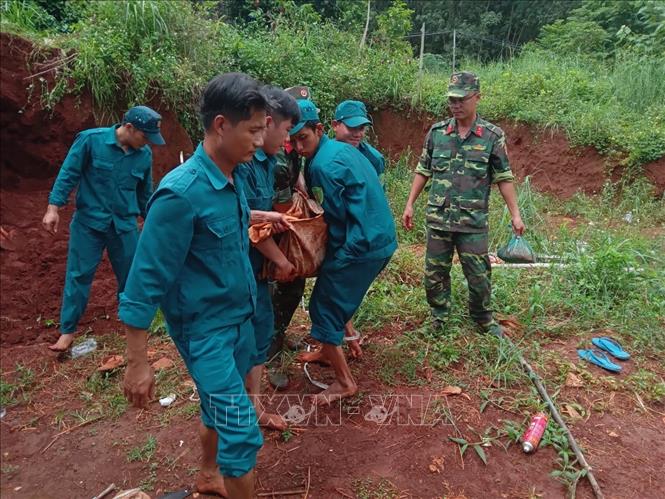 Trong ảnh: Di dời đầu đạn pháo 175mm được phát hiện trong vườn nhà dân. Ảnh: TTXVN phát
