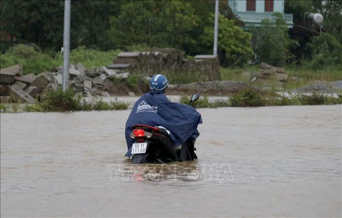 Trong ảnh: Nhiều phương tiện giao thông bị chết máy do ngập nước. Ảnh: Văn Tý-TTXVN