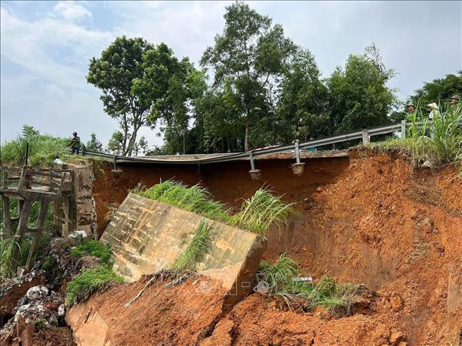 Cống tiêu Ngòi Tre, đoạn Tỉnh lộ 317A bị sạt lở ăn sâu vào lòng đường, tạo thành hàm ếch gây nguy hiểm cho người và các phương tiện giao thông. Ảnh: Tạ Toàn – TTXVN