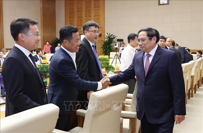 Thủ tướng Phạm Minh Chính với các đại biểu dự Hội nghị phát triển thị trường khoa học và công nghệ. Ảnh: Dương Giang-TTXVN
