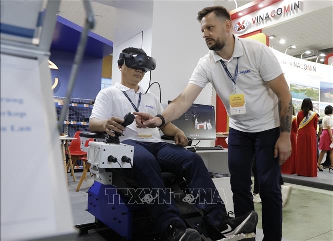 Introducing a vehicle for miner transporting at the Exhibition. VNA Photo: Trần Việt