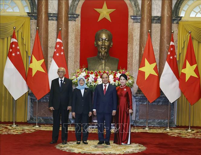 Nguyễn Xuân Phúc và Phu nhân cùng Tổng thống Cộng hòa Singapore Halimah Yacob và Phu quân tại lễ đón. Ảnh: Thống Nhất-TTXVN
