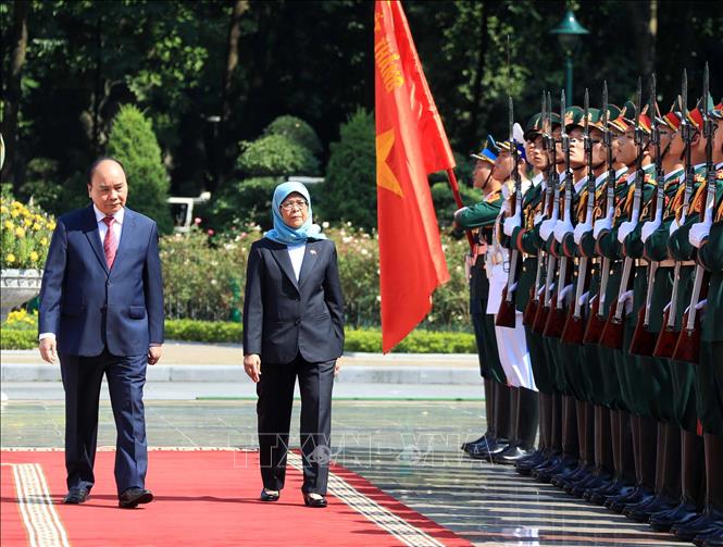 Chủ tịch nước Nguyễn Xuân Phúc và Tổng thống Cộng hòa Singapore Halimah Yacob duyệt Đội danh dự QĐND Việt Nam. Ảnh: Thống Nhất – TTXVN