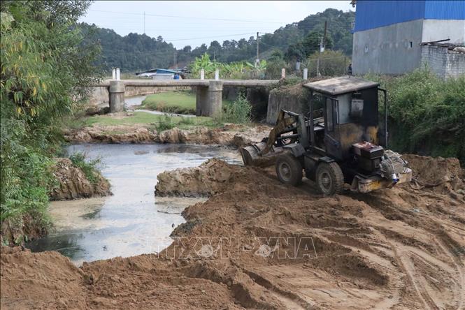 Một chủ cơ sở chế biến dong riềng trên địa bàn thành phố Điện Biên Phủ (tỉnh Điện Biên) phải bồi lấp bãi thải, trả lại mặt bằng cho lòng suối, đảm bảo an toàn vệ sinh môi trường. Ảnh: Xuân Tiến – TTXVN 