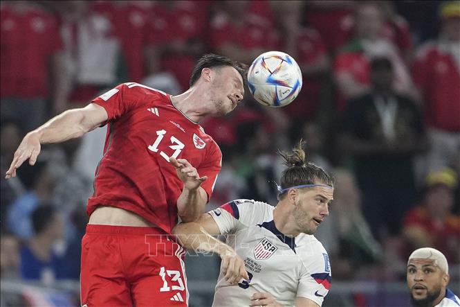 Trong ảnh: Pha tranh bóng bổng giữa Kieffer Moore (trái) của Xứ Wales với tuyển thủ Mỹ. Ảnh: THX/TTXVN