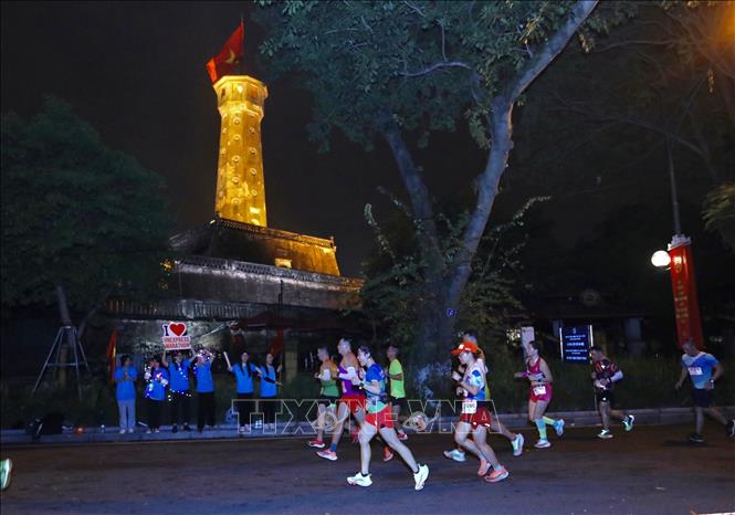 Các VĐV chạy trên phố Điện Biên Phủ, qua cột cờ Hà Nội. Ảnh: Hoàng Hiếu - TTXVN 