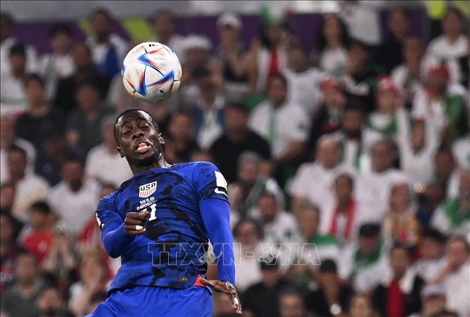 Tiền đạo Mỹ Timothy Weah (số 21) có cơ hội đánh đầu trong vòng cấm của Iran, nhưng pha dứt điểm của cầu thủ này quá nhẹ nên không gây được khó khăn cho thủ môn Alireza Beiranvand. Ảnh: AFP/ TTXVN