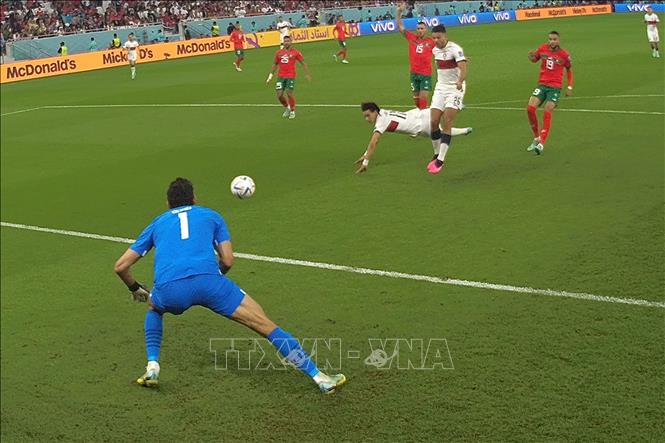 Từ quả tạt bên cánh phải, tiền đạo Joao Felix (giữa) tuyển Bồ Đào Nha chọn vị trí đánh đầu hiểm hóc nhưng thủ môn Yassine Bounou (trái) đã đổ người cản phá xuất sắc cứu thua cho Maroc. Ảnh: AFP/ TTXVN