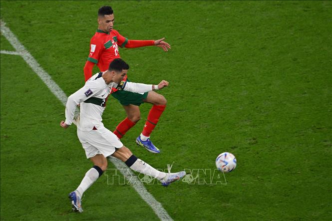 Tiền đạo Bồ Đào Nha Ronaldo (số 7) bứt tốc nhận đường chuyền của đồng đội sau đó dứt điểm rất căng, nhưng thủ môn Yassine Bounou của Maroc một lần nữa lại cứu thua xuất sắc. Ảnh: AFP/ TTXVN